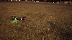 Drone trying to take off from grassy field in evening