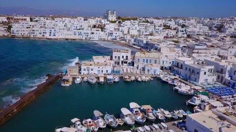 Aerial bird's eye view video taken by drone of iconic and picturesque port of Naousa village, Paros island, Cyclades, Greece