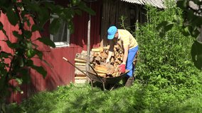 worker man placing cut log in row along wooden home wall in sunny day. 4K UHD video clip. 