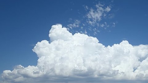 Time lapse clip of white fluffy clouds over blue sky, Puffy fluffy white clouds blue sky time lapse motion background. Bright blue sky puffy fluffy white cloud cloudscape cloudy heaven. Puffy fluffy.