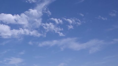 Time lapse clip of white fluffy clouds over blue sky, Puffy fluffy white clouds blue sky time lapse motion background. Bright blue sky puffy fluffy white cloud cloudscape cloudy heaven. Puffy fluffy.
