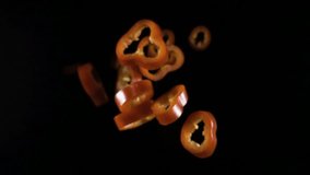 Creative concept with flying red paprika. Sliced floating pepper isolated. Levity capsicum vegetable isolated on black background. macro - Powered by Shutterstock - Get 15% off with code: PIKWIZARD15