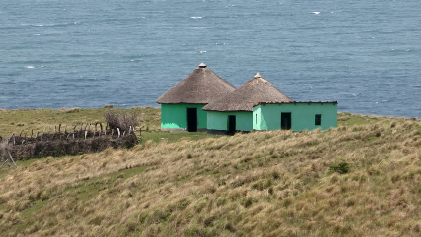 Traditional Xhosa huts with the Indian Ocean in the background,