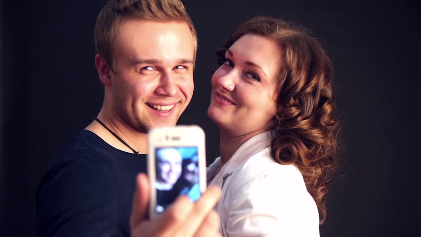 young couple making photo and smiling