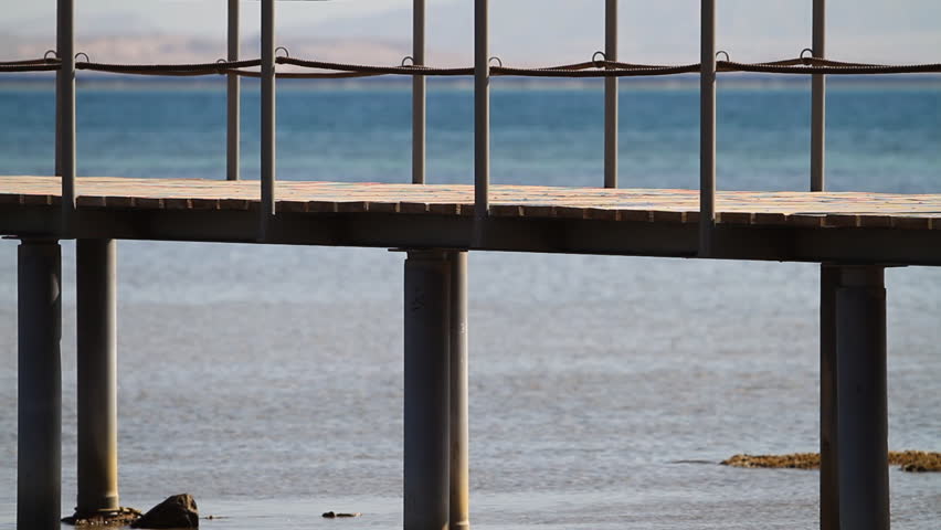 People walking on the wooden pier