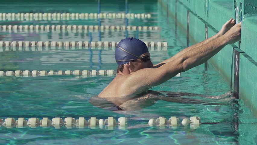 Slow Motion Of Professional Male Swimmer Pushing Off In Streamline 