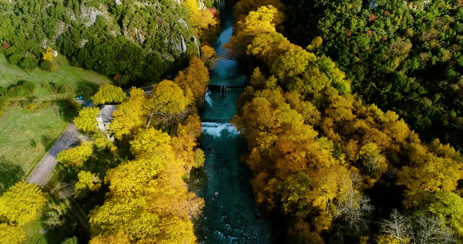 Aerial flight with drone over the Vikos Canyon and the Old Stone Bridge of the Klidonia an Autumn Day in in Zagorochoria., Greece.