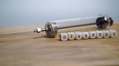 Diabetes icon letters word in front of old syringe