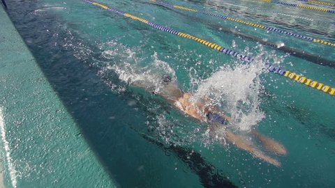 Professional Swimmer Training The Butterfly Stroke. Close Shot In Slow Motion.