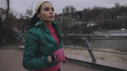 Woman jogging outdoor in cold winter day