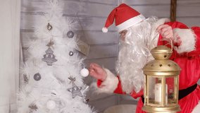 Santa is holding a Christmas golden lantern