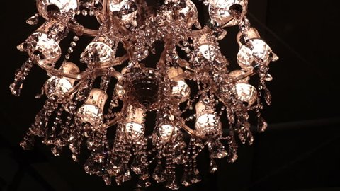 crystal chandelier on black background, luxury fashion object