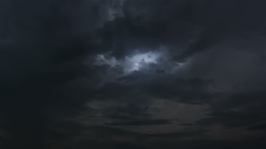 Thunderstorm clouds at night with lightning. 4K Timelapse Loop. Evening thunderstorm video landscape background. Impressive lightning storm sky. Several powerful flashes and lights.