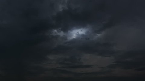 Thunderstorm clouds at night with lightning strikes. 4K Timelapse Loop. Evening lightning strikes video landscape background. Impressive lightning storm sky. Several powerful flashes and lights.	
