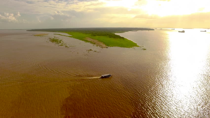 Cinematic aerial shot over the meeting of the Black River and Amazon