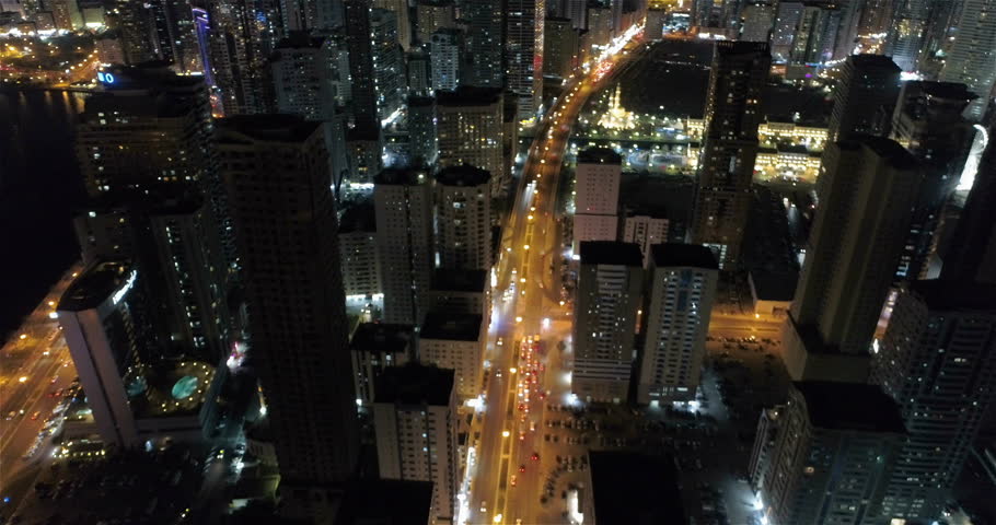 Night flight over the metropolis. View from above. Sharjah,  UAE.