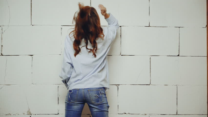 Young fashionable woman posing in stylish wearing in studio