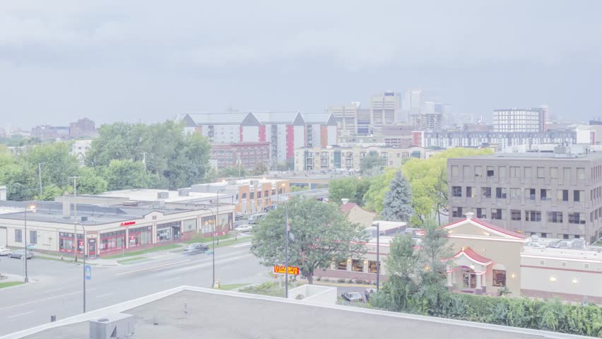MINNEAPOLIS, MN - SEPTEMBER 2017 - A Wide Angle Twilight Shot of Stormy Weather Moving Over Minneapolis and the Stadium Village Neighborhood near the University as Car Traffic Passes in the Foreground