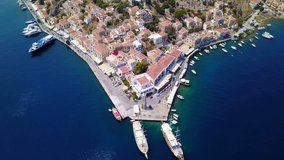 Aerial bird's eye video taken by drone of Yalos, iconic port of Symi island, Dodecanese, Greece