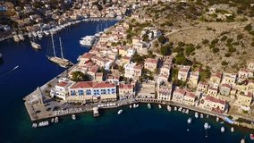 Aerial bird's eye video taken by drone of Yalos, iconic port of Symi island, Dodecanese, Greece