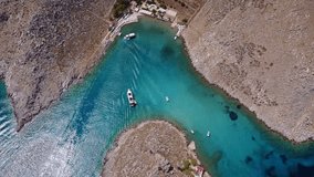 Aerial birds eye view video taken by drone of famous tropical beach of Agia Marina, Symi island, Dodecanese, Greece