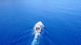 Aerial birds eye view video taken by drone of traditional fishing boats cruising