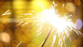 Sparkler with light on yellow background