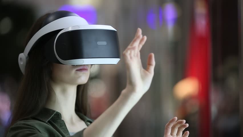 woman uses a virtual reality glasses indoors Royalty-Free Stock Footage #33355000