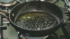 Butter Poured And Tossed With Oil In Skillet On Stove