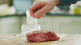 Man Sprinkling Salt Over Raw Meat On Cutting Board