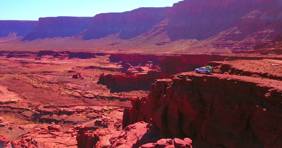 Gray Pick-Up Truck With Tent Camper In Bright Red Rock Canyon Overlook