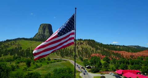American Flag Waving In Breeze Outside Devil's Tower, Wyoming - Aerial Flyover Pan View