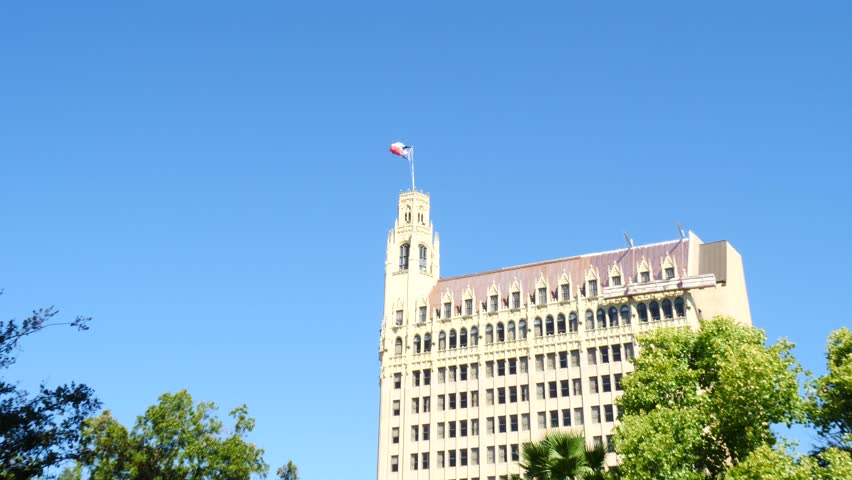 Texas Flag Flying High Above High Rise Building at Alamo Zoom