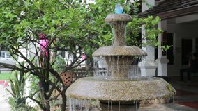 Three-tiered garden fountain flowing with water, stock video