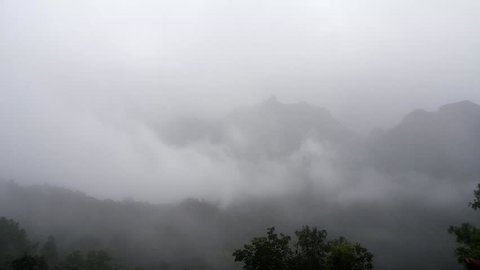 Timelapse of mist and clouds moving fast over green mountains , Located Doi Luang Chiang Dao at Chiangmai , Thailand