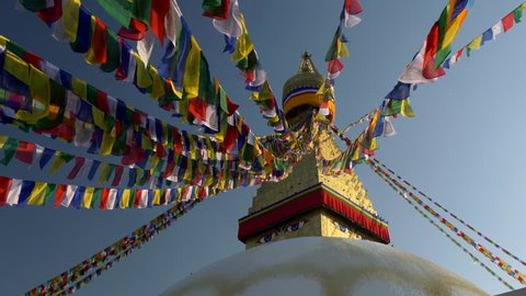 Prayer flags at Boudhanath Stupa in sunrise lights. Kathmandu, Nepal . Crane shot, UHD, 4K