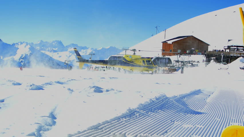 VAL THORENS, JANUARY 25 - Mountain helicopter taking off from a ski piste.