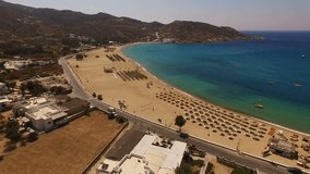 Aerial bird's eye view video taken by drone of beautiful tropical beach of Mylopotas, Ios island, Cyclades, Greece