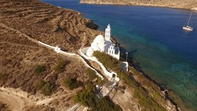 Aerial birds eye view video taken by drone of famous church of Agia Eirini in port of Ios island, Cyclades, Greece
