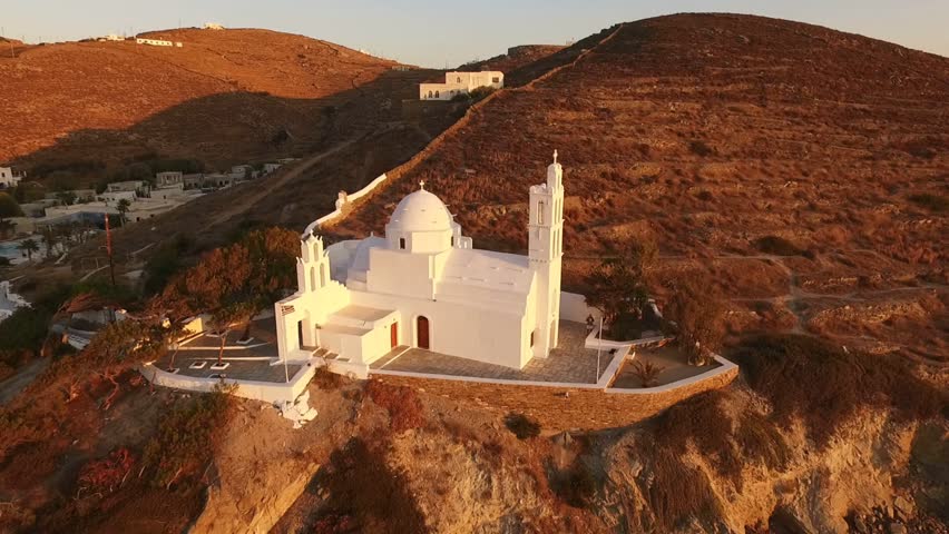 Aerial birds eye view video taken by drone of famous church of Agia Eirini in port of Ios island, Cyclades, Greece