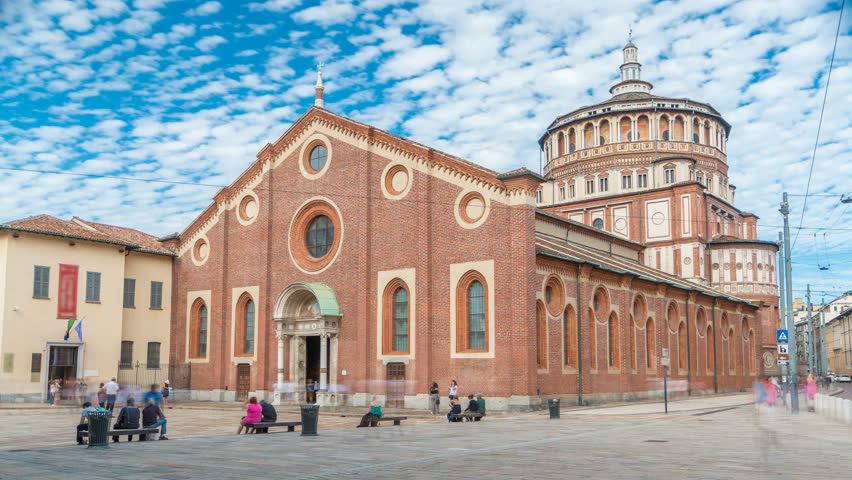 Santa Maria delle Grazie timelapse with blue cloudy sky. Milan, Italy. People walking around. This church and the adjacent Dominican convent were built during the 15th century.