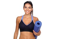 Cheerful brunette sports woman holding fitness mat and looking at the camera over white background