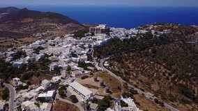 Aerial bird's eye view video taken by drone of Massive fortified stone Monastery of Saint John the Apostle, Patmos island, Greece