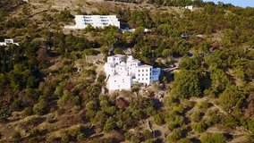 Aerial birds eye view video taken by drone of Monastery of Saint John the Theologian where he wrote the book of Revelation, Patmos Island, Dodecanese, Greece