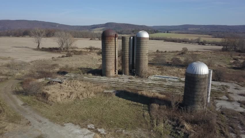 Old Farm Silos AERIAL flyover Late Fall in New England, Upstate NY.