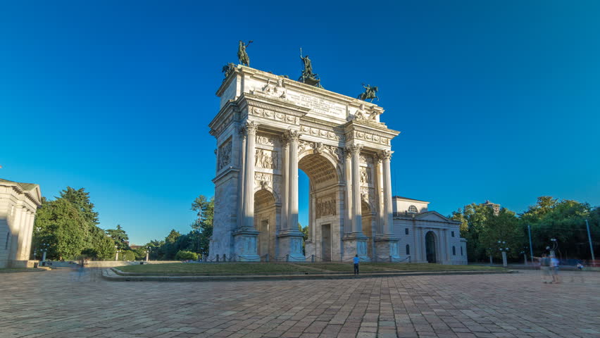 Arco della Pace in Piazza Sempione (Arch of Peace in Simplon Square) timelapse hyperlapse. It is a neoclassical triumph arch, 25 m high and 24 m wide, built between 1807 and 1838. Blue cloudy sky at