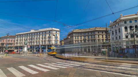 Cordusio Square and Dante street with surrounding palaces, houses and buildings timelapse hyperlapse in Italian capital of fashion and luxury. Trams passing by. Monument to writer and poet Giuseppe