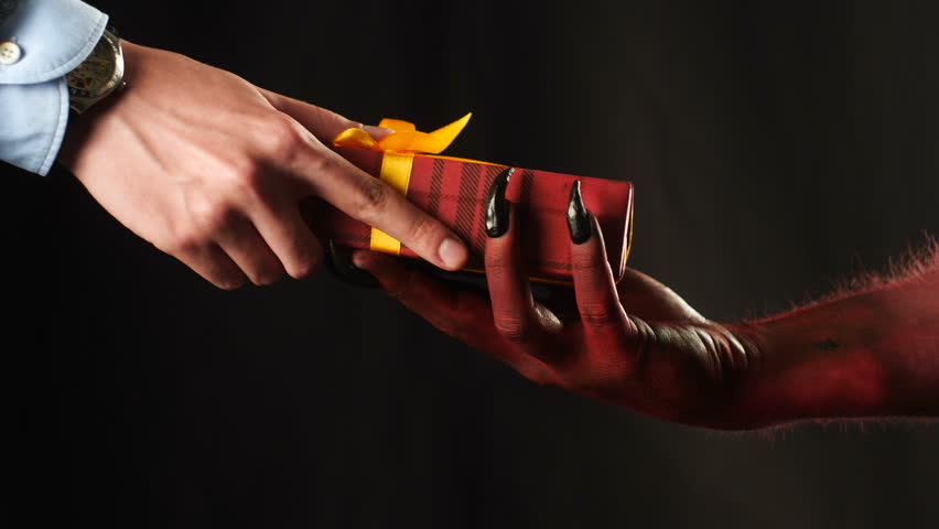 Red demon hand gives a gift to the businessman. 50 fps | Shutterstock HD Video #33388567