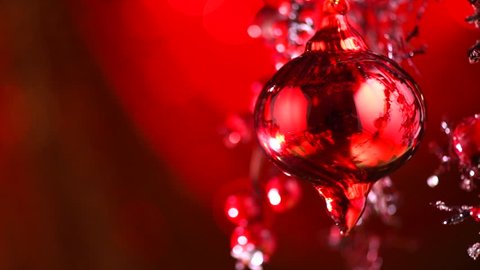 Christmas and New Year Red Decoration. Abstract Blurred Bokeh Holiday Background with beautiful baubles and Blinking Garland. Christmas Tree Lights Twinkling. Xmas backdrop. 4K UHD slow motion video