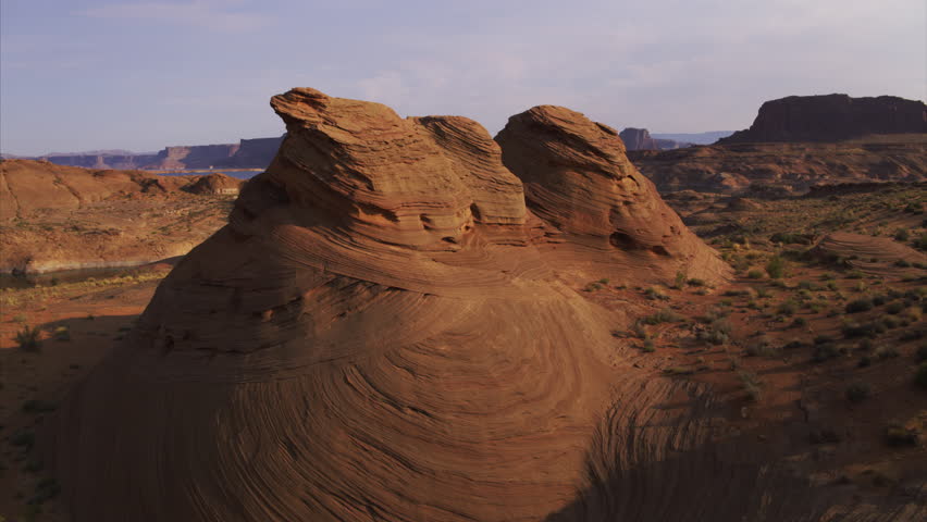 Aerial view of clouds over conical rock formation in desert / Lake Powell, Arizona, United States